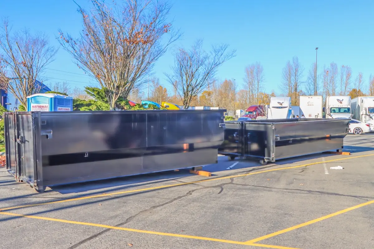 Professional dumpster rental service with roll-off container on residential driveway in Cascades